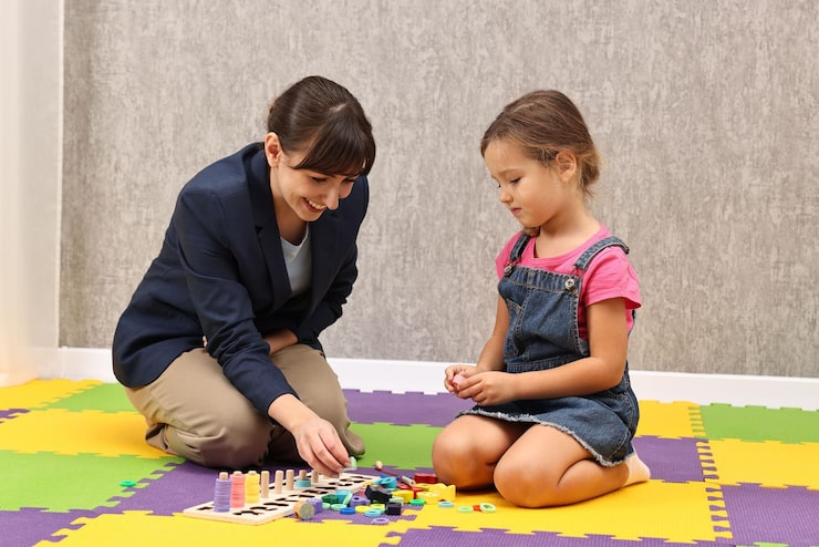 autism-therapy-smiling-psychologist-little-girl-playing-with-educational-toy-mental-health-center_495423-117842